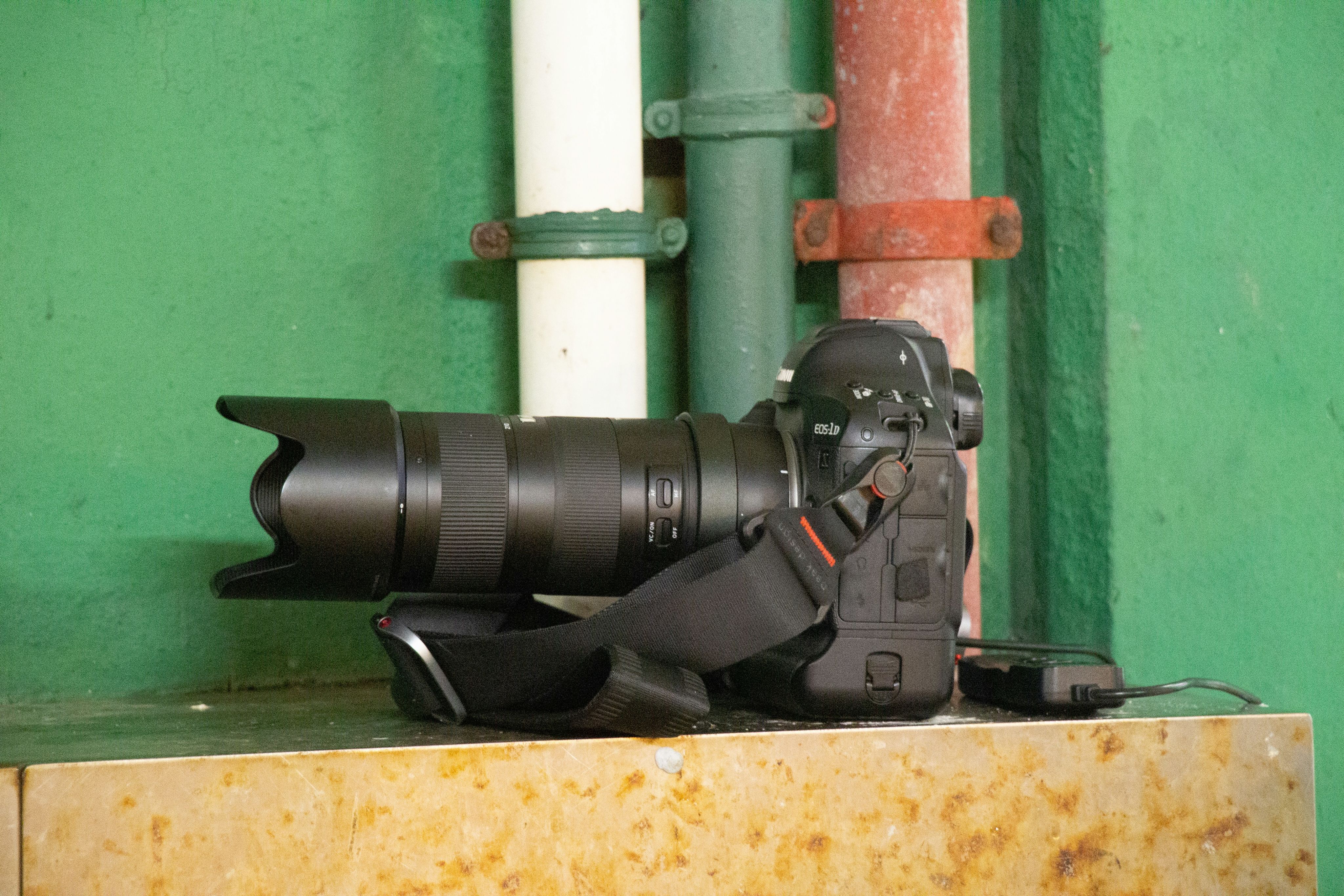 a black drill on a piece of wood