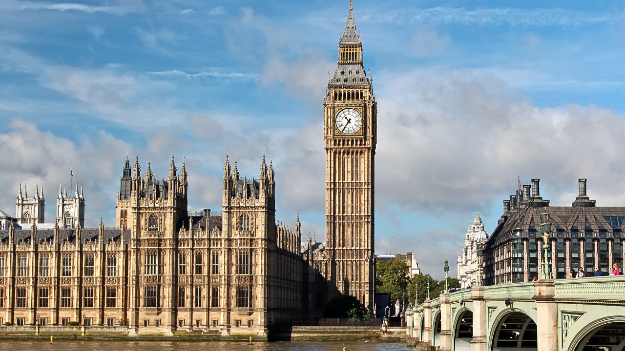 Photo of the Big Ben clock in Westminster, London surrounded by a bridge and buildings