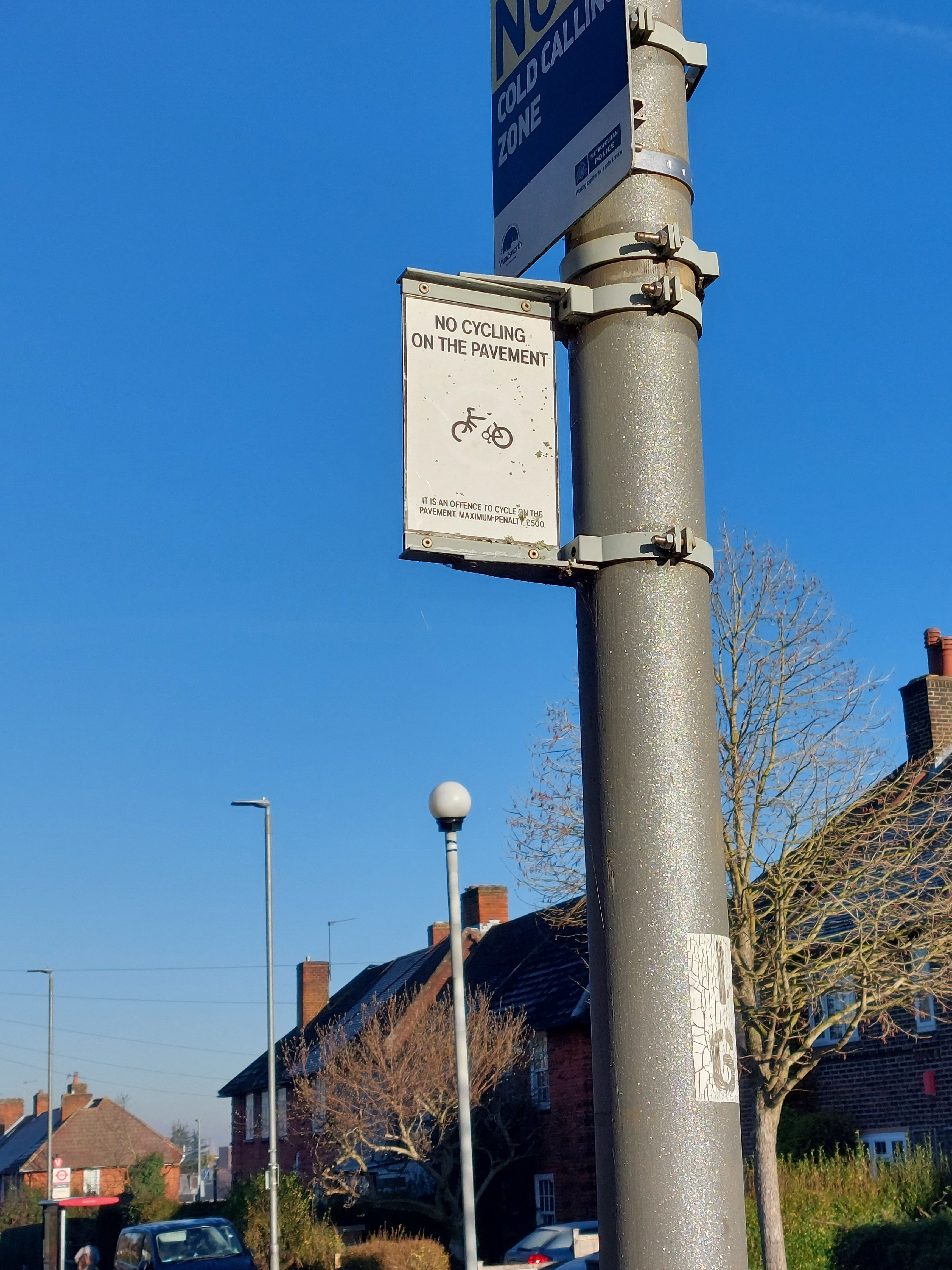 A sign reading: 'No cycling on the pavement'