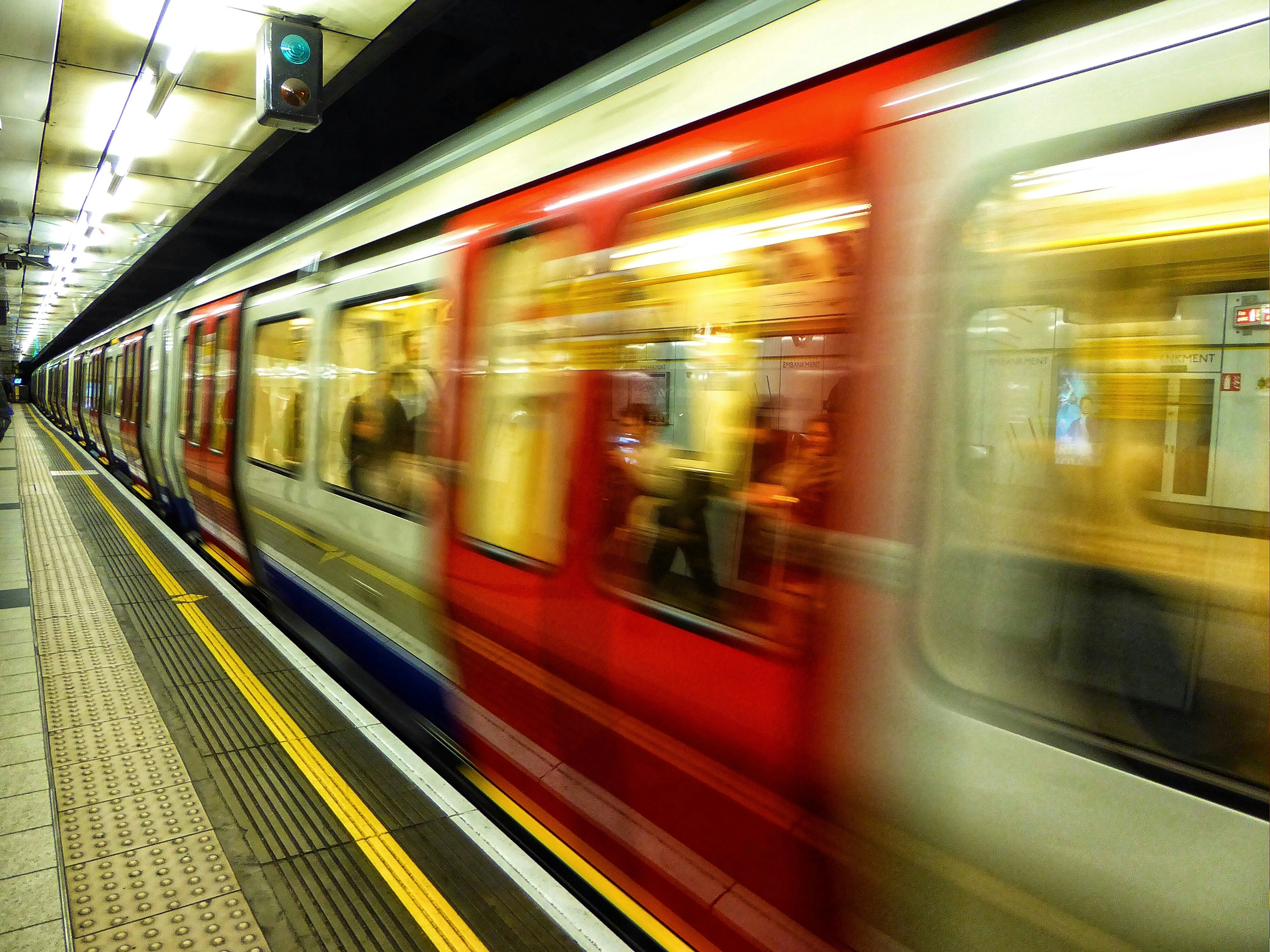 Blurred underground train pulling out of a station
