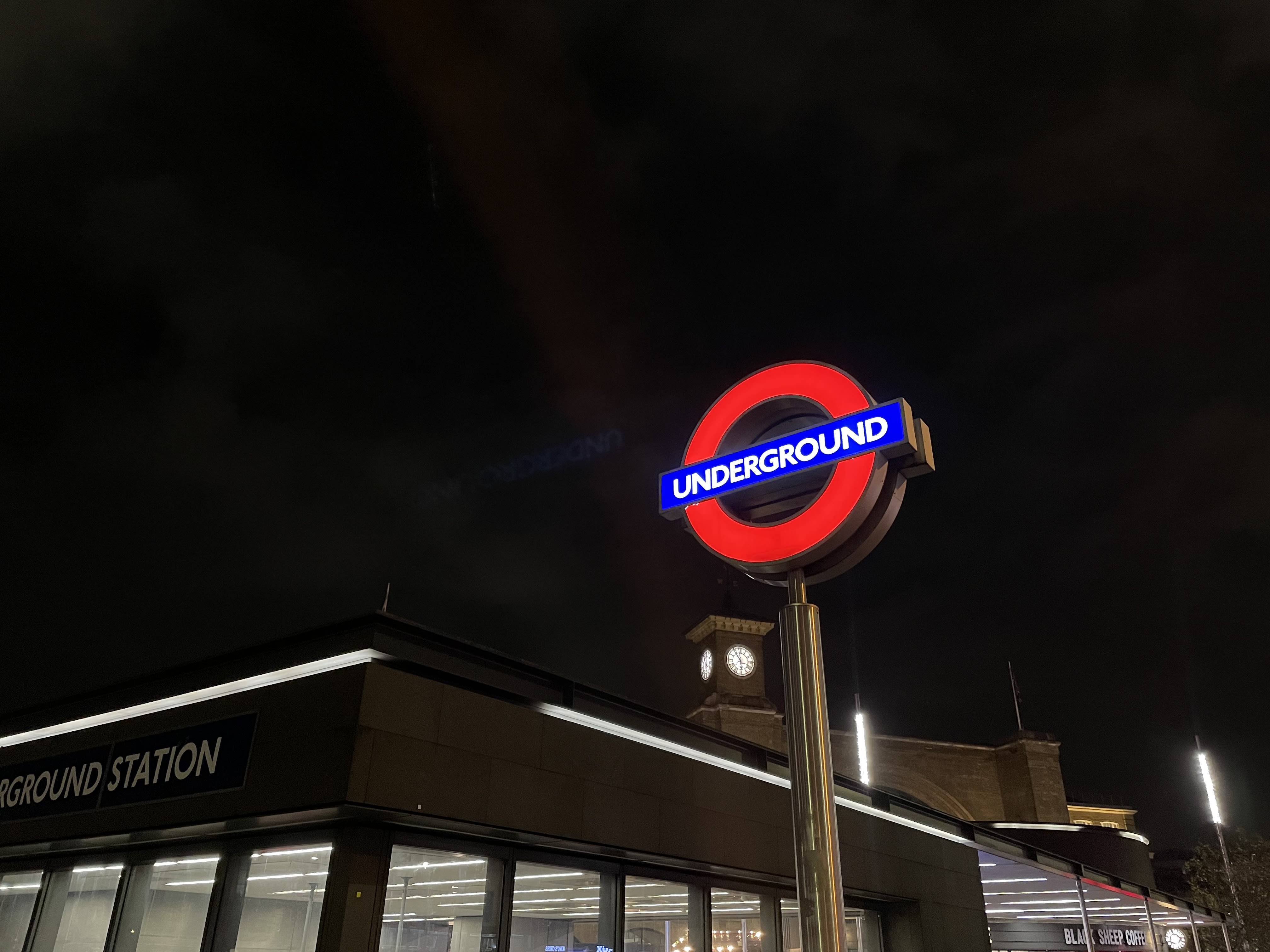 London Underground sign lit up at night