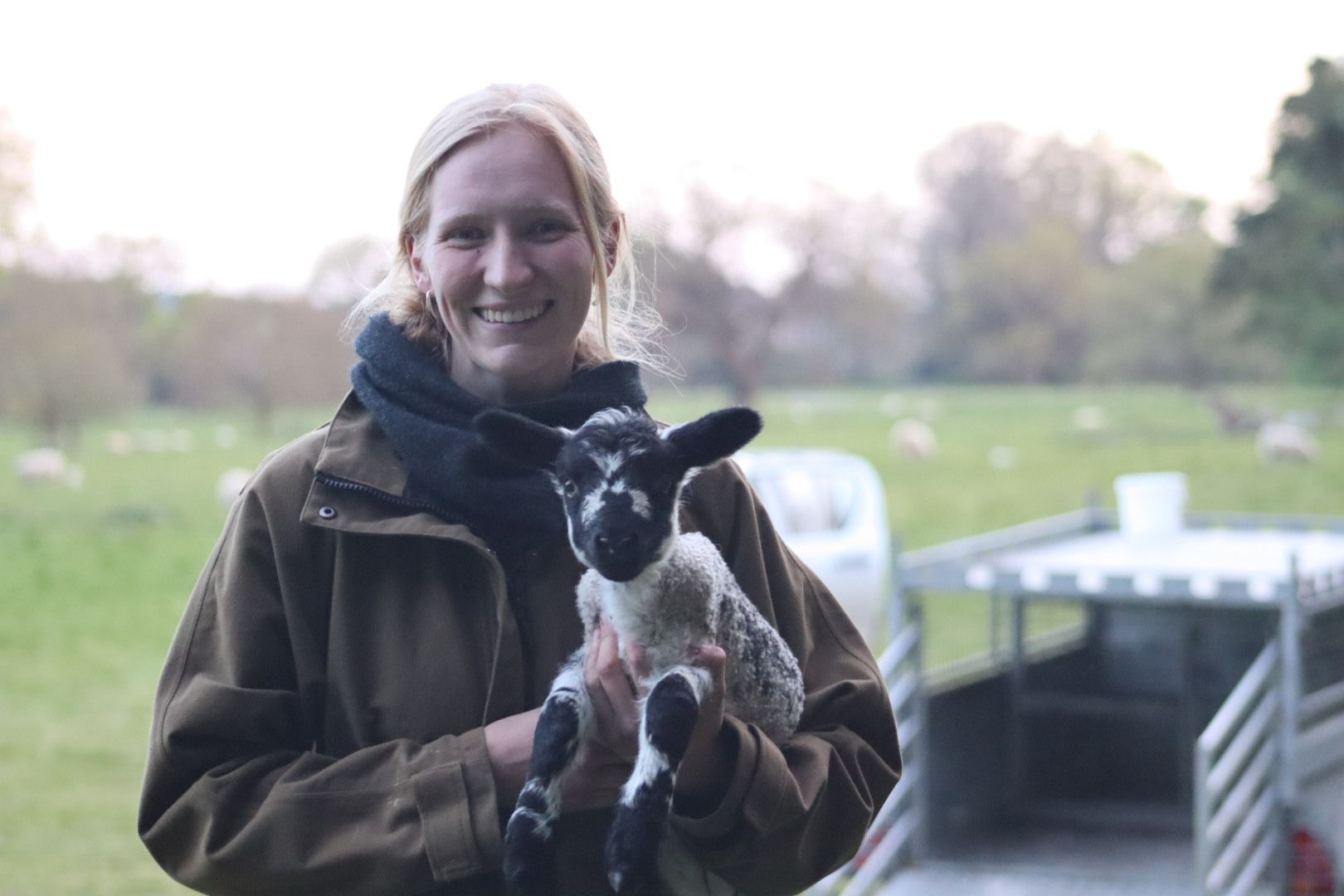 Tilly Abbott carrying a lamb 