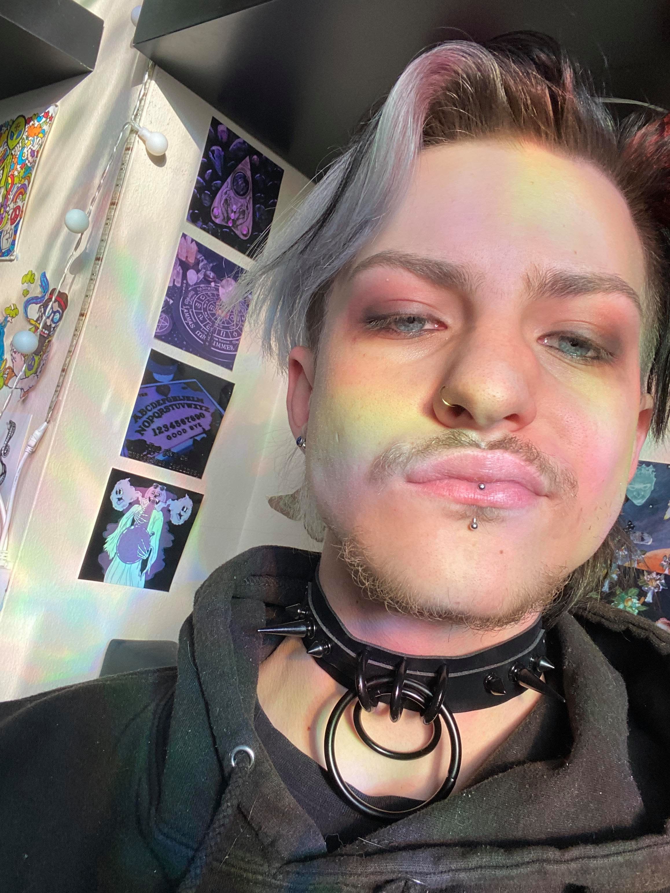 A person is pouting. A rainbow sheen decorates their face.
