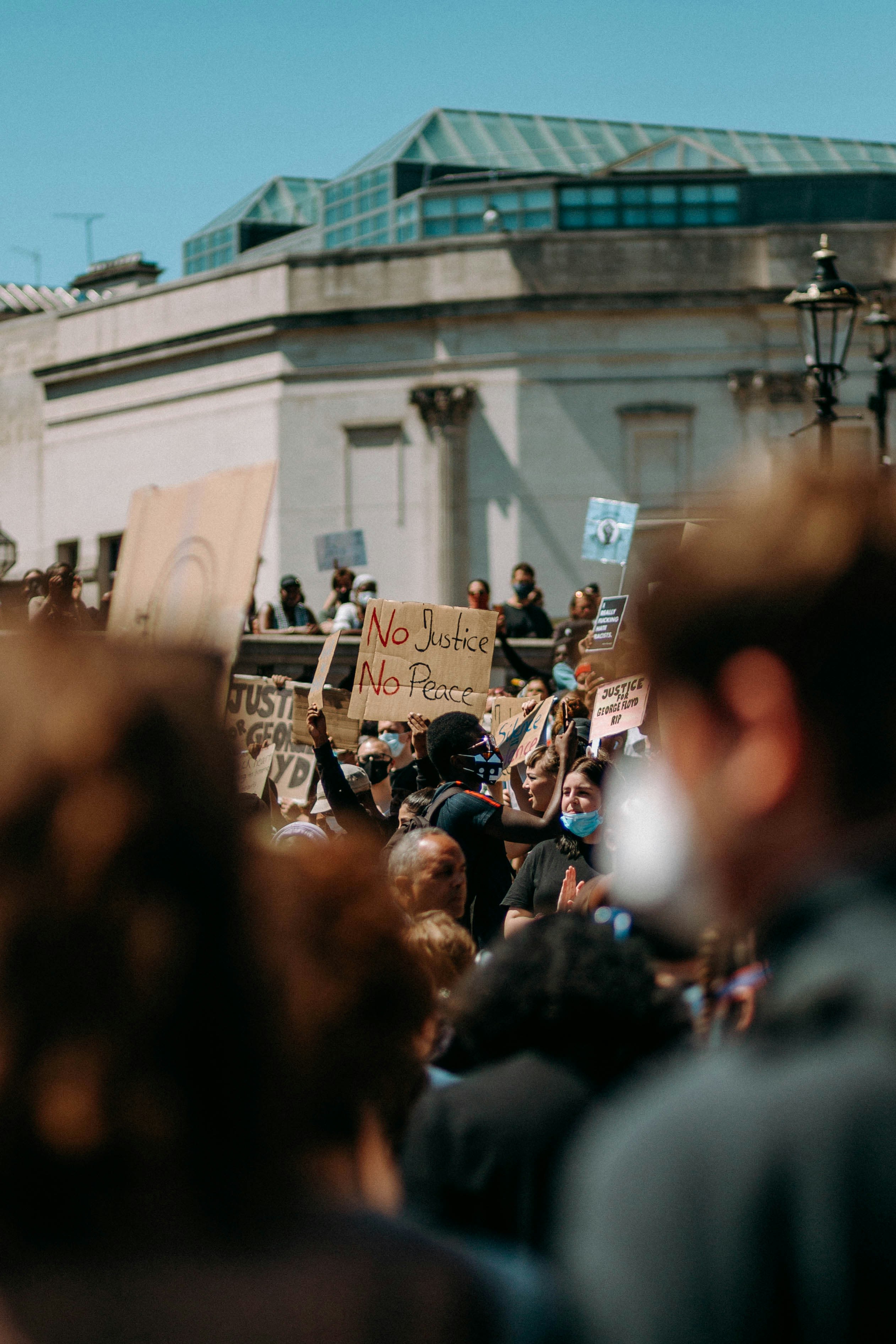 people walking on street during daytime at a protest