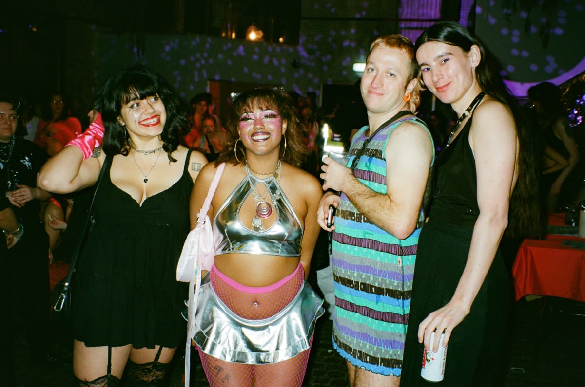 Group of friends smiling and posing in a nightclub