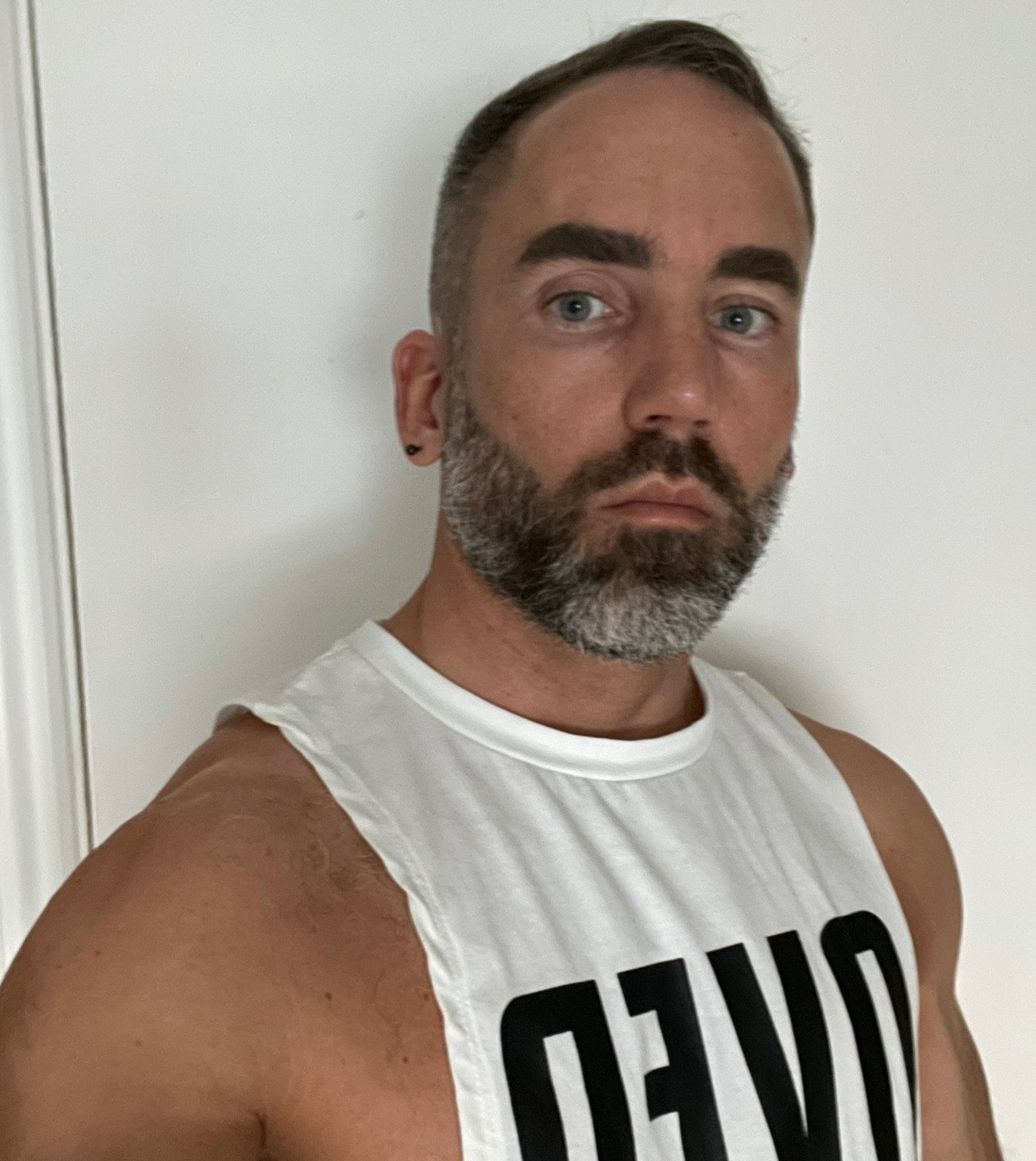 Sam Thomas wearing white vest