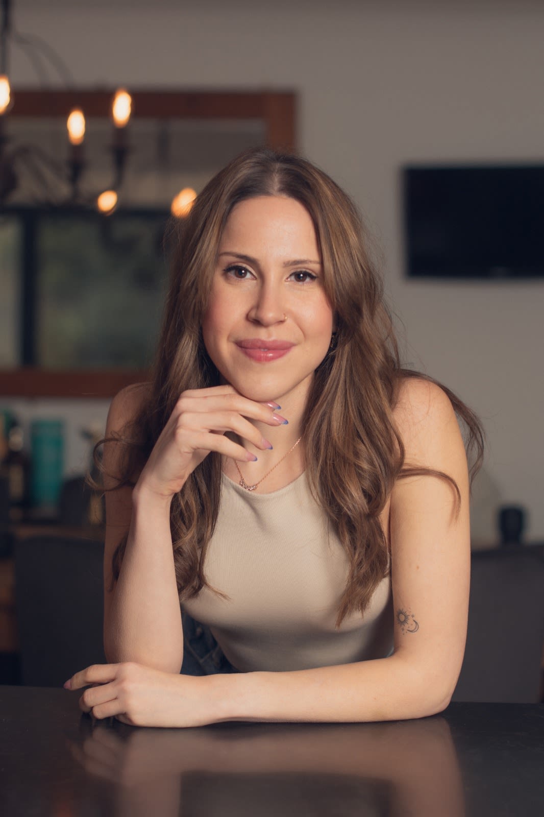 Ciandra Birnbaum leaning on table with chin resting on hand