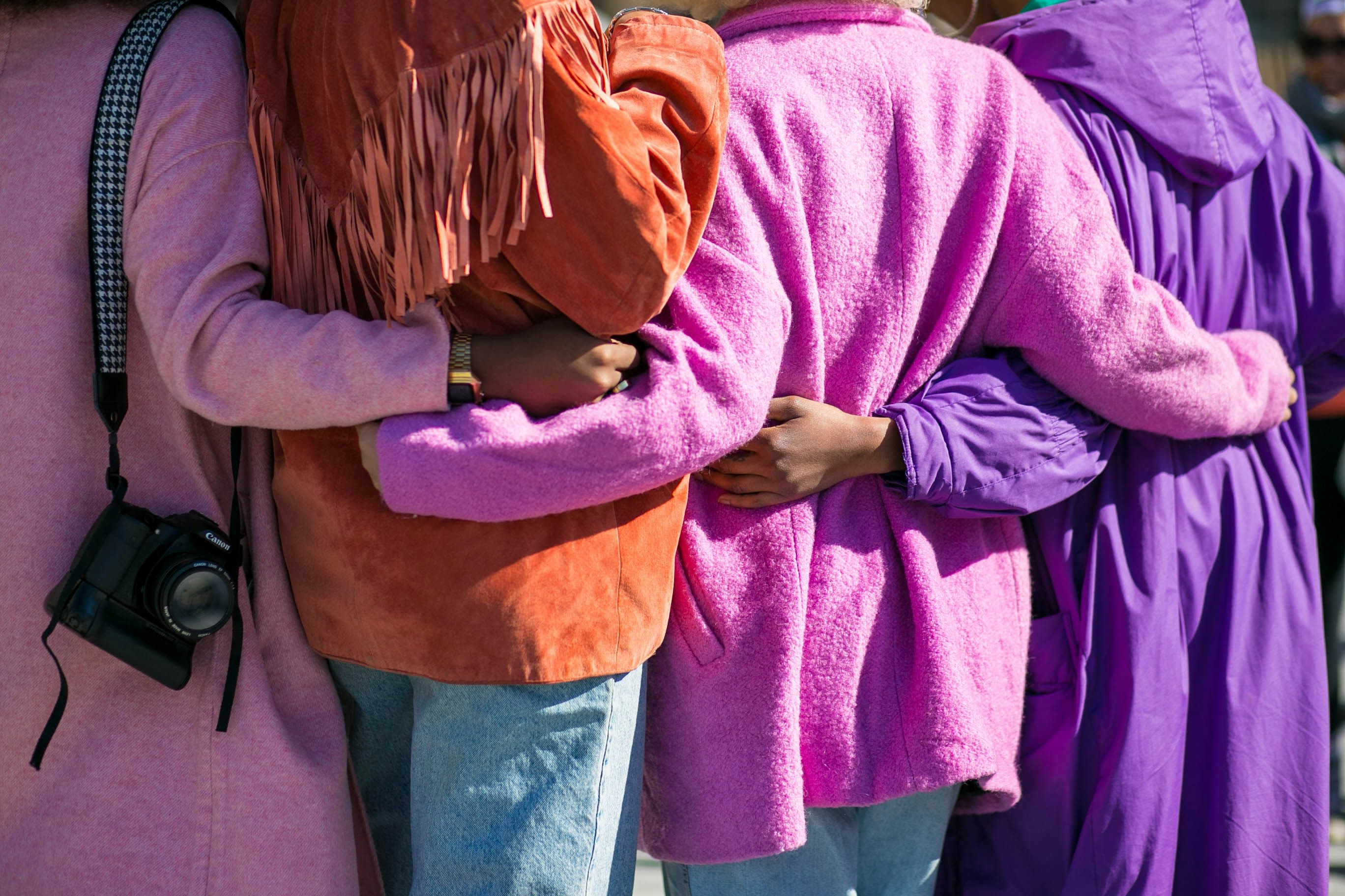 a group of ladies at a photo walk in NYC linking arms
