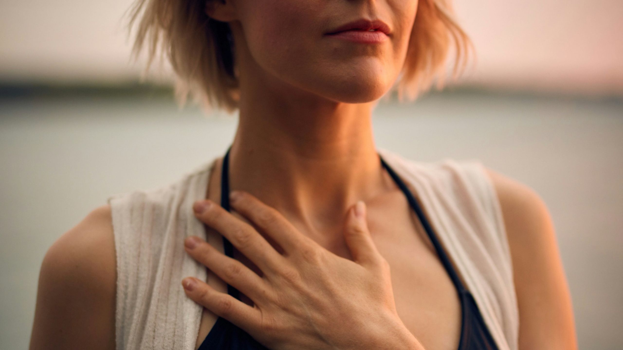 woman with her hand on her heart