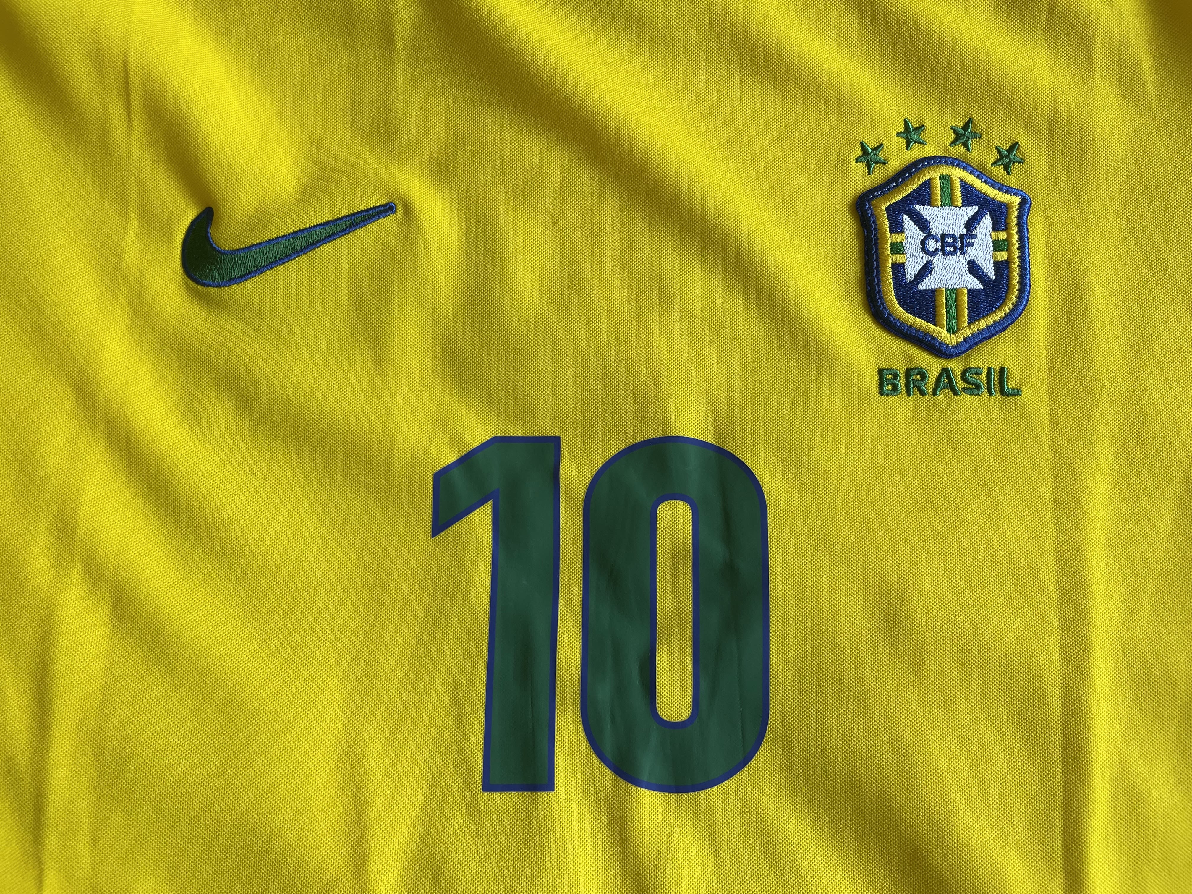 Brazil yellow shirt with green Nike tick, Brazil badge with 4 stars and the number 10