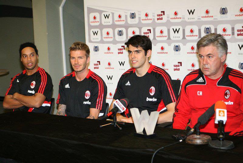 Carlo Ancelotti in an AC Milan red and black tracksuit top with Kaka, David Beckham and Ronaldinho