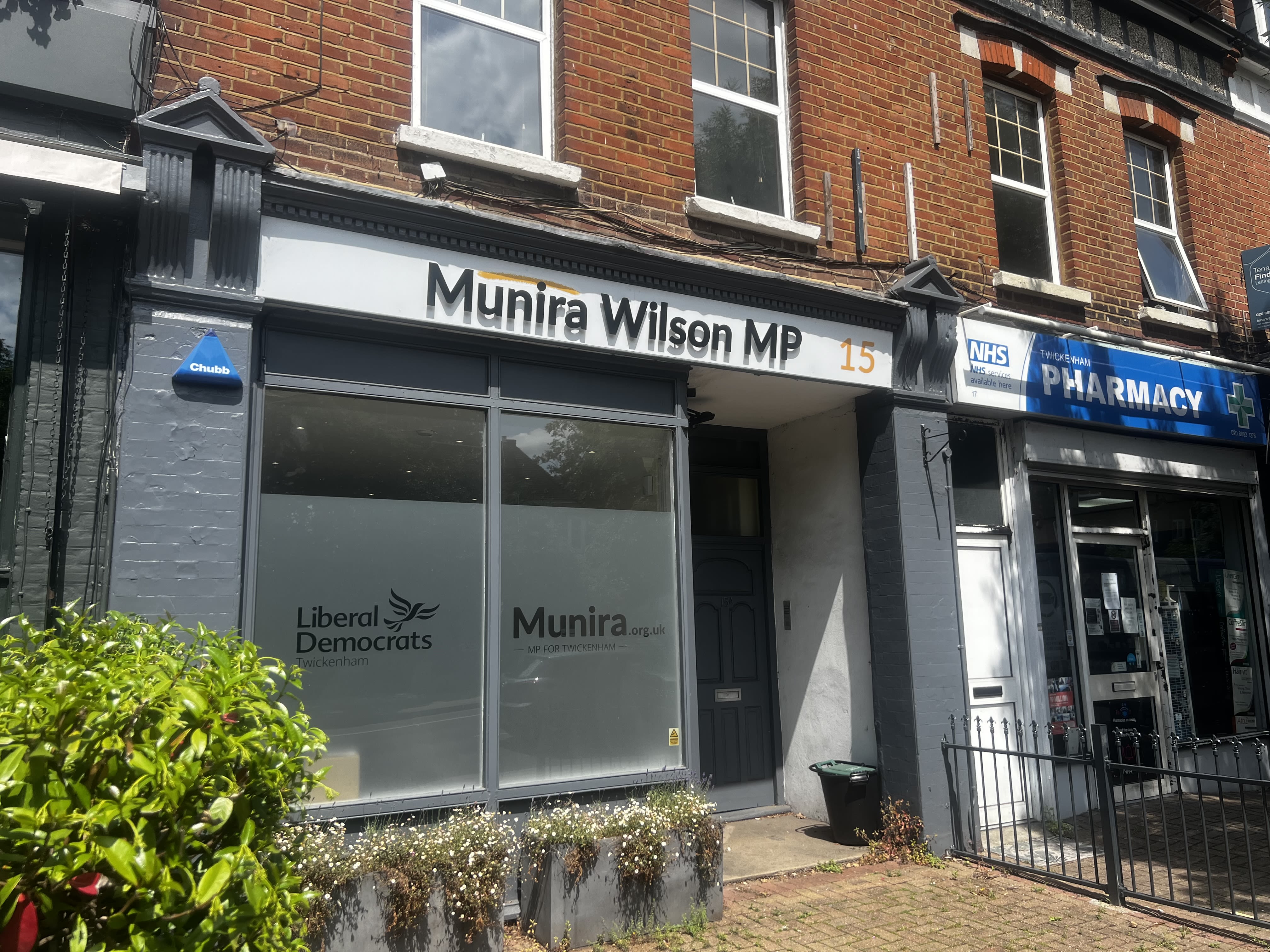 A grey building front displaying the words Munira Wilson MP atop.