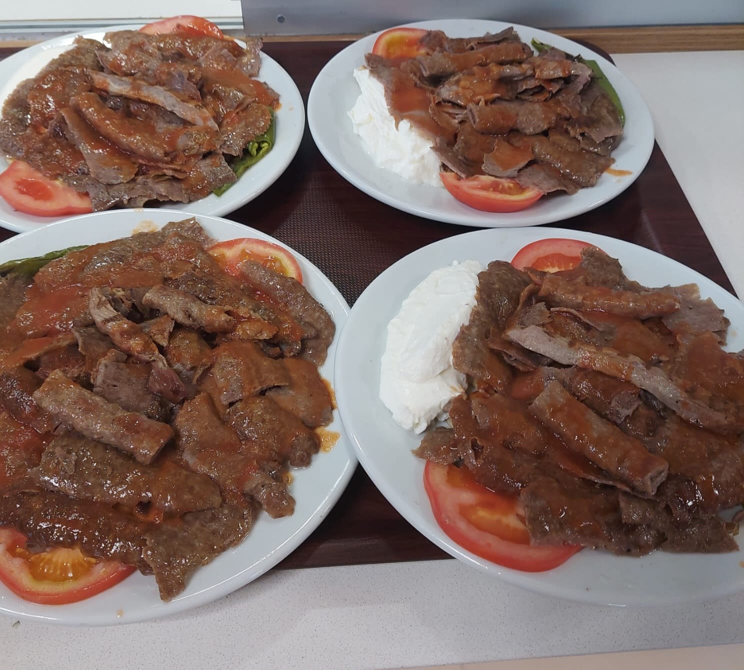 a large piece of meat is being cooked on a grill