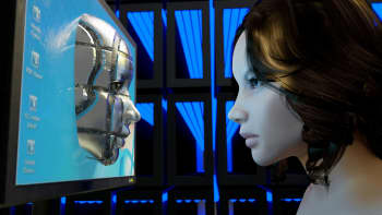  A girl looks at a metal face on a computer