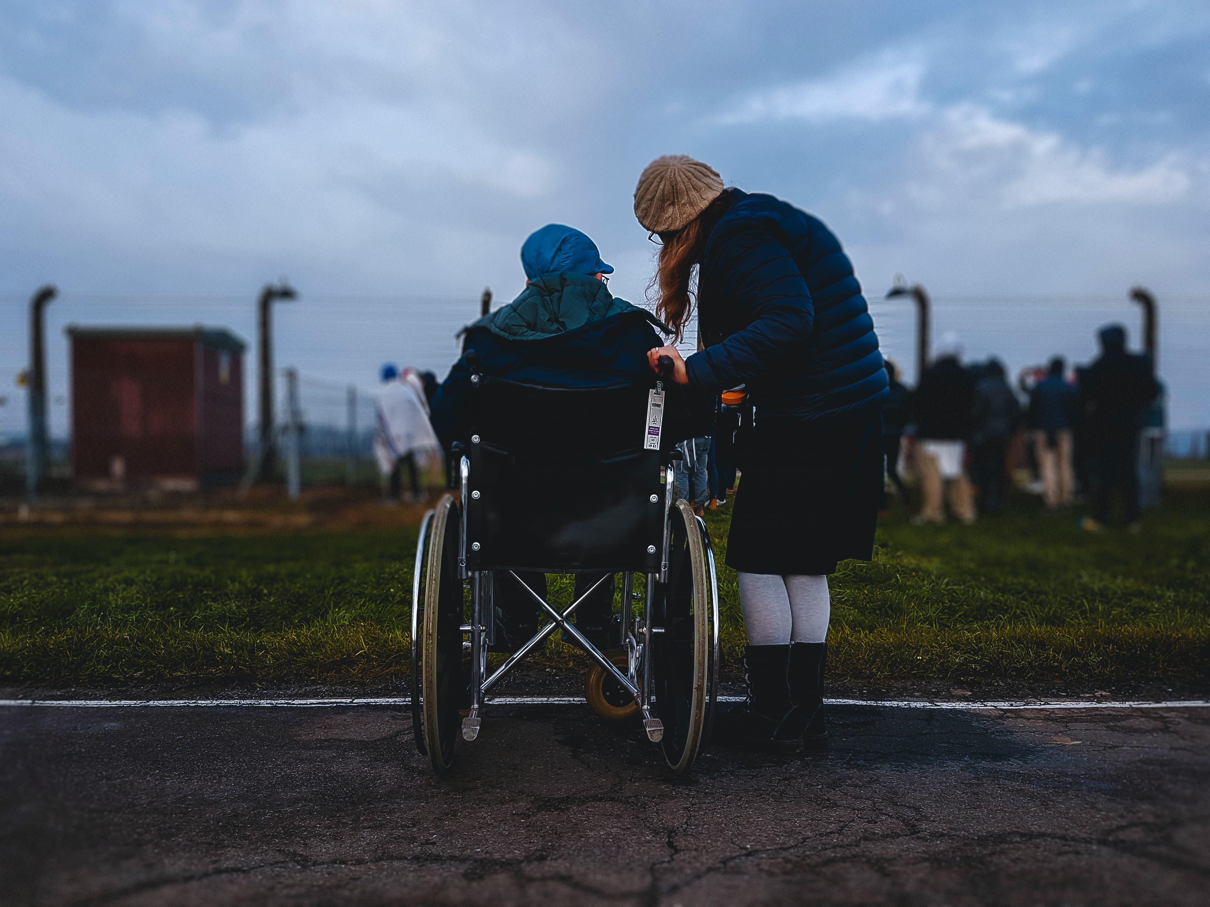 A woman looks after someone in a wheelchair