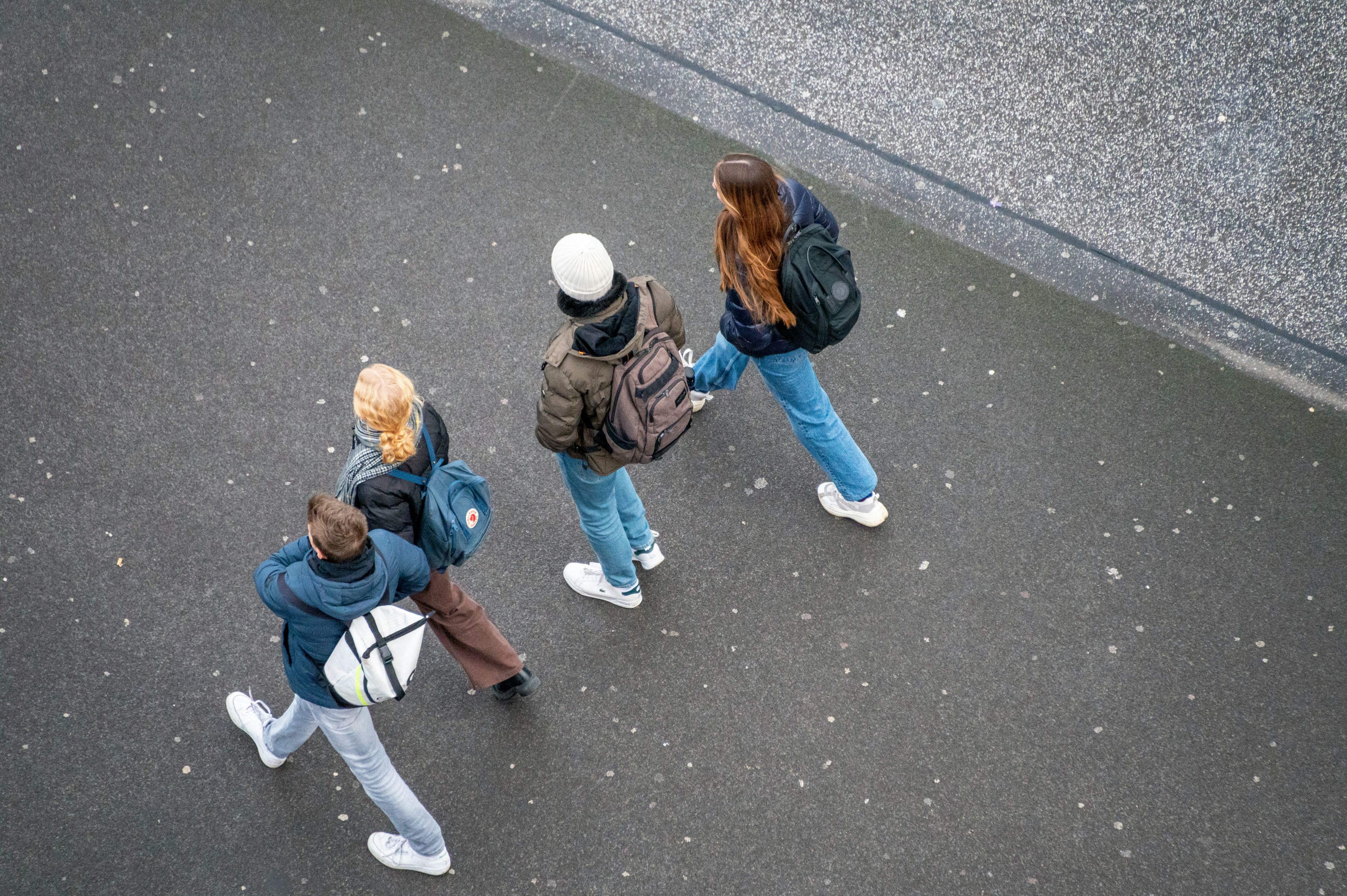 Young people with backpacks walking