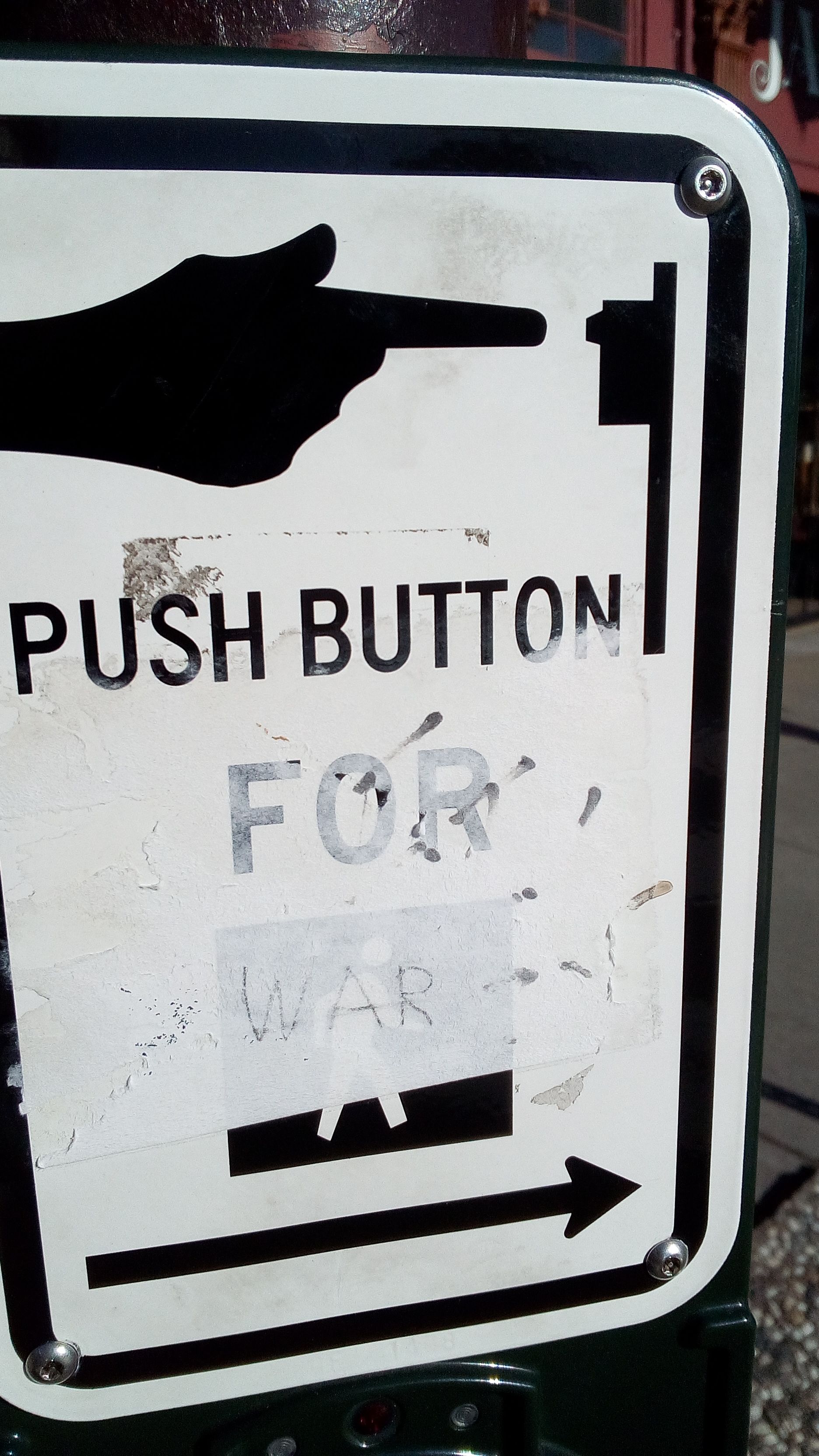 An American walking sign saying push for war